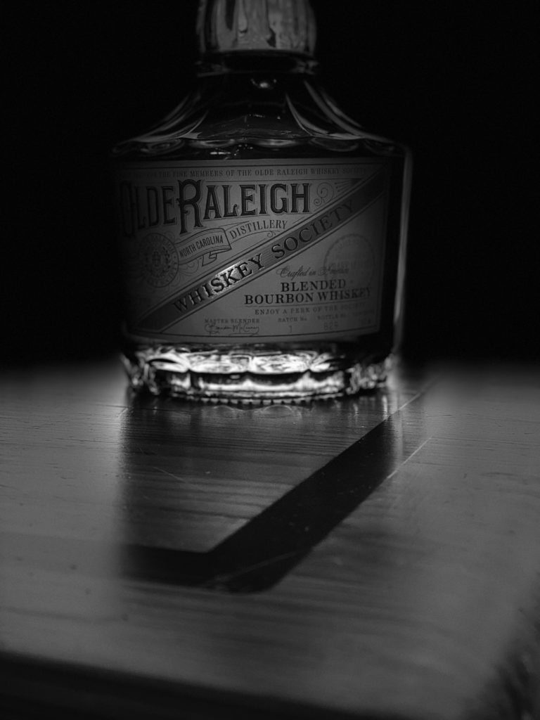 black and white silhouette of olde raleigh bottle