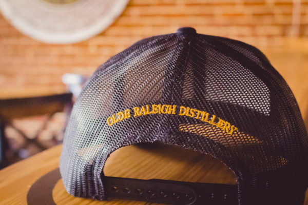baseball cap with olde raleigh distillery on the back